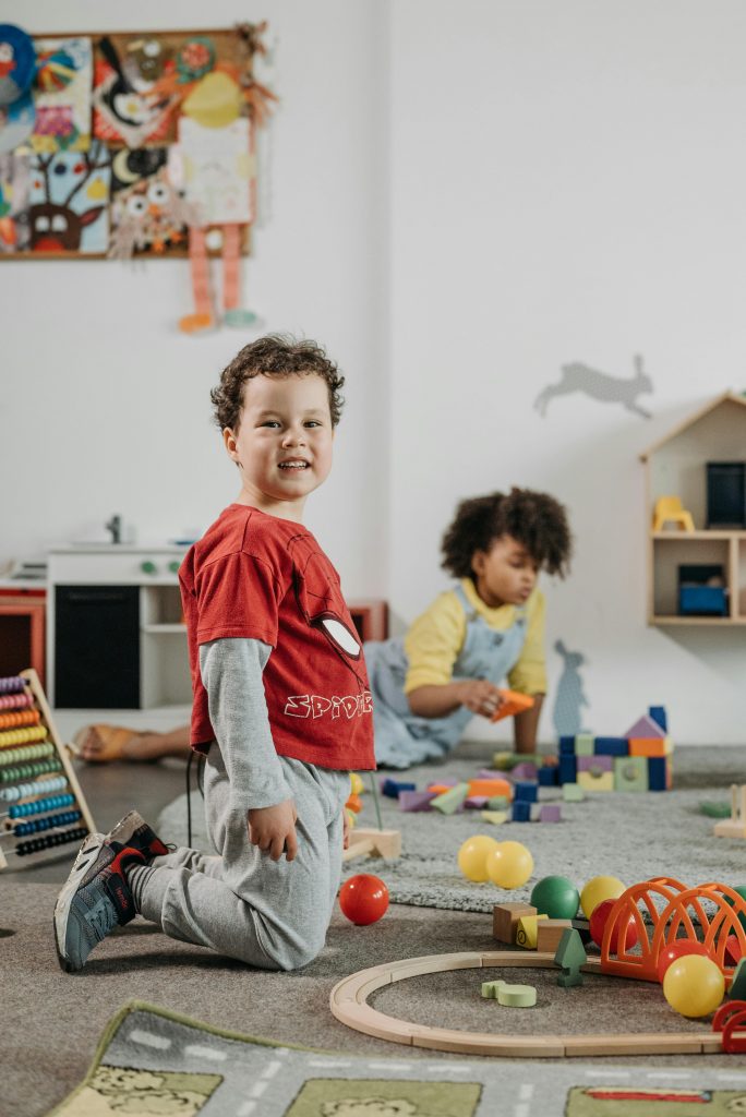 Cheerful children playing with toys in a cozy kindergarten setting.